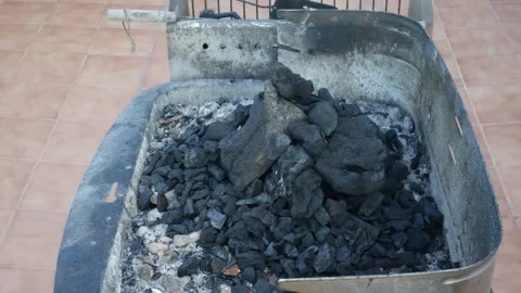 Time lapse of a barbecue, shows the process of igniting the charcoal and cook Stock Footage 136372839