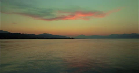 Time lapse of bay sunset with a ship and stars 4K Stock Footage 49152841