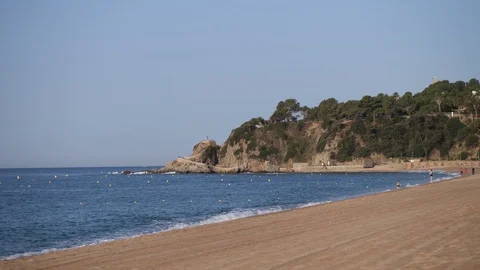 Time lapse beach life. The waves hit the shore, seagulls fly, people run. 4K Stock Footage 114888922