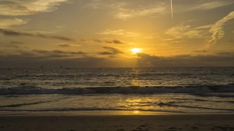 Time-Lapse Beach Sunset with Out-of-Focus People Walking on Sand Stock Footage 301336756