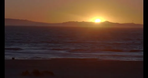 Time-lapse Beach Sunset sun going down with couple watching sitting in the sand Stock Footage 292956608
