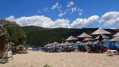 Time lapse of beach, tourists under parasol, swimming in the sea.Cloud formation Stock Footage 91138403
