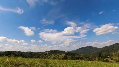 Time lapse: beautiful clouds floating by the sky above mountains in sunny day. Stock Footage 159236747