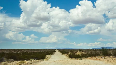 Time Lapse - Beautiful Clouds Moving Over the Mountain Ranges with Road Stock Footage 61739993