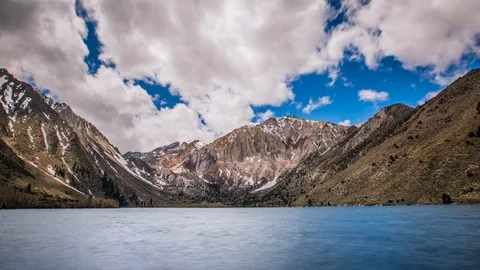 Time Lapse - Beautiful Clouds Moving Over the Mountain Range by the Lake  - 4K Stock Footage 90448908