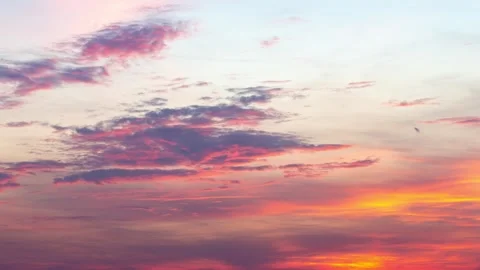 Time lapse of beautiful clouds turning from bright orange to black Stock Footage 246963947