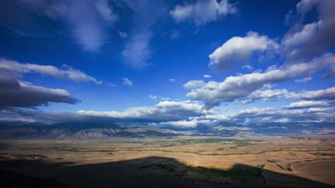 Time Lapse - Beautiful cloudscape moving over mountain range and the valley Stock Footage 222668117