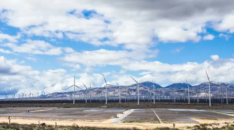 Time Lapse - Beautiful Cloudscape over Solar Panel and Wind Turbine Field Stock Footage 49089322