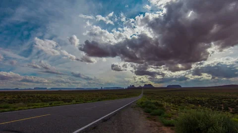 Time Lapse - Beautiful Cloudscape over Monument Valley Road Stock Footage 56592815