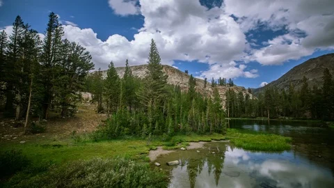 Time Lapse - Beautiful Cloudscape over the Mountain Range with Meadow -  4K Video stock 117176346