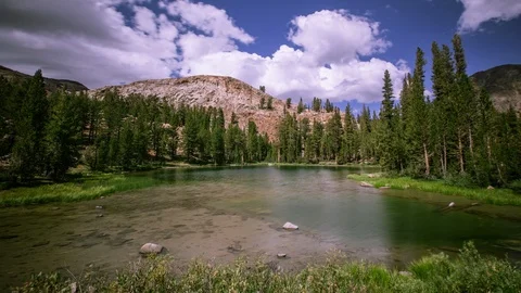 Time Lapse - Beautiful Cloudscape over the Mountain Range with Meadow -  4K Stock Footage 118885489