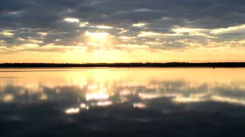 Time lapse of beautiful colorful clouds over water Stock Footage 67436636