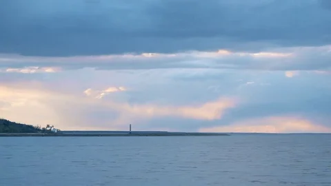Time lapse of beautiful colorful clouds moving over water landscape with Stock Footage 74868922