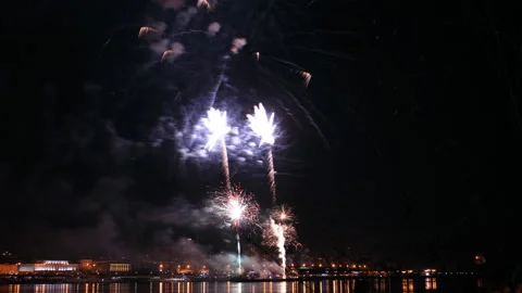 Time lapse of a beautiful fireworks display at the city festival over the river. Video stock 89659866