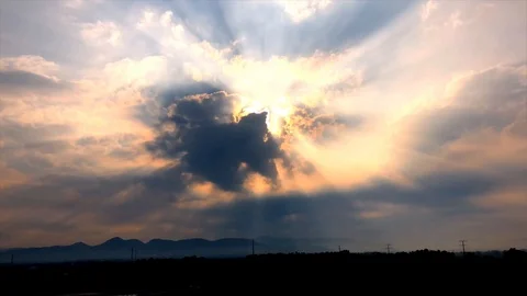 Time lapse : Beautiful rays of sun breaking through the clouds Stock Footage 104525924