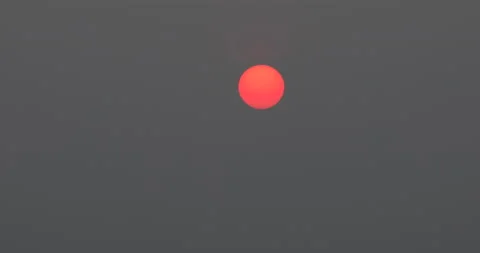 Time lapse of beautiful red sun rising from behind mountains Stock Footage 162711587