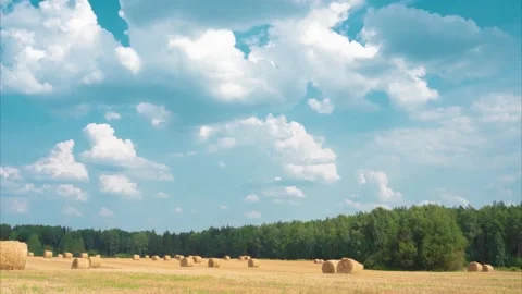 Time Lapse of beautiful scenery with clouds ,field in the background. Harvested Stock Footage 168223253