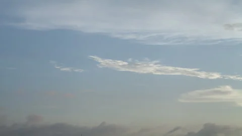 Time lapse of beautiful sidelit clouds in fast motion, with a blue sky backgroun Stock Footage 273266285