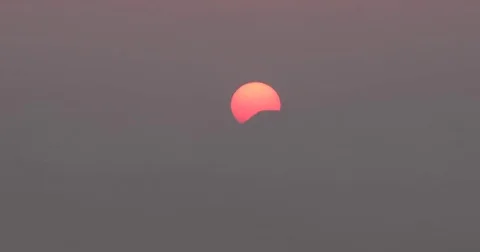 Time lapse of beautiful sun rising behind mountain against gray blurred clouds Stock Footage 73590449