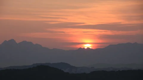 Time lapse of beautiful sun rising from behind mountains Stock Footage 162710957