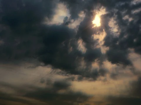 Time lapse of Beautiful sunlight rays through dark storm clouds at sunset Stock Footage 76481586