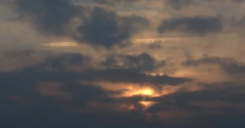 Time lapse of beautiful sunrise through dark clouds : 4K footage Stock Footage 71634818