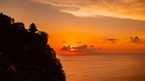 Time Lapse - Beautiful Sunset above the Sea at Uluwadu Temple in Bali - 4K Stock Footage 100650934