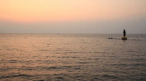 Time lapse of beautiful sunset with ocean and lighthouse Stock Footage 54316727