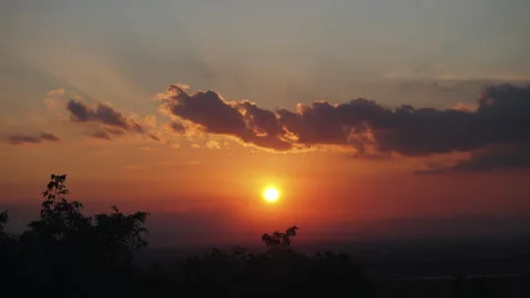 Time lapse Beautiful sunset over a mountain with colorful orange clouds Stock Footage 296206704
