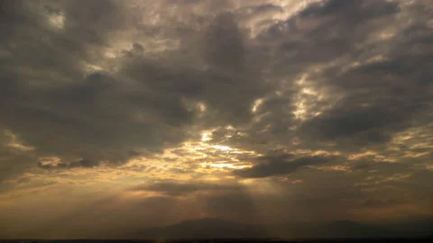 Time lapse of beautiful sunset sky with golden rays of sun and white clouds. Stock Footage 220110580