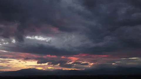 Time lapse of beautiful sunset sky with golden rays of sun and white clouds. Stock Footage 220168993