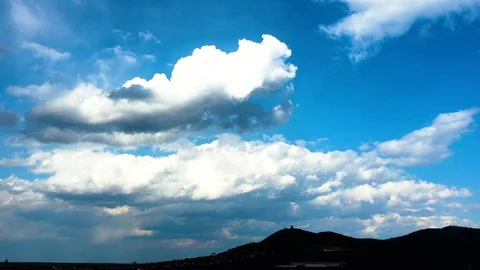 Time lapse beautiful white clouds in the blue sky above the hill Stock Footage 125527518