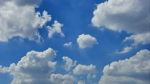 Time-lapse of beautiful white fast moving puffy cumulus clouds on a sunny day Stock Footage 260172089