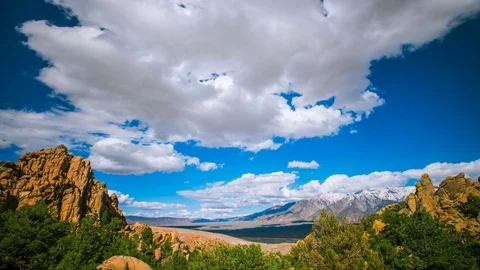 Time Lapse - Beautiul Clouds Moving Over Mountain Range and Valley - 4K Stock Footage 74247538