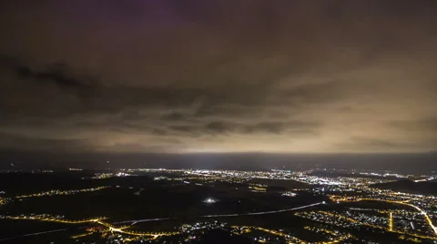 Time lapse of big clouds moving quickly over the city in the night Stock Footage 61163394
