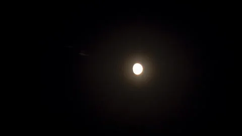 Time Lapse Of Big Moon Rising Or Moving Through Warm Air In The Night Sky A.. Stock Footage 345088444