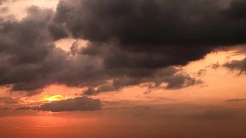 Time lapse of big orange sun setting down to the horizon on the red sky Stock Footage 126709818