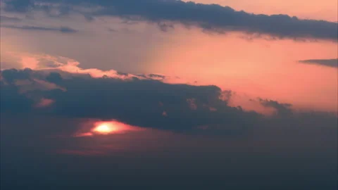 Time lapse of big sun, setting down in dense dark clouds. The sky is burning red 스톡 동영상 234205455