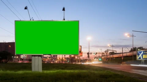 Time Lapse. A Billboard with a Green Screen on a Busy Night Street Stock Footage 99755733