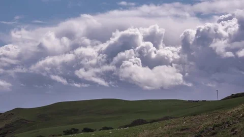 Time-Lapse of billowing clouds over filed in the Scottish Countryside Stock Footage 72930559