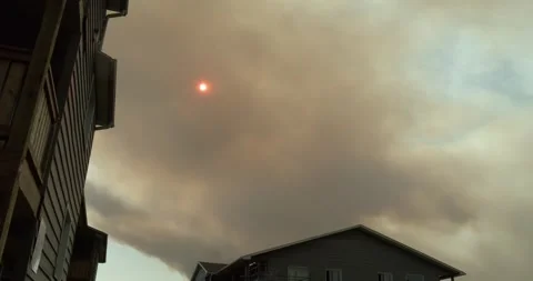 Time Lapse Black smoke from a forest fire will cover the sun in the sky. Stock Footage 242507092