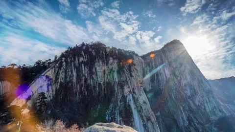 Time Lapse of Blazing Sun Twin Peaks Steep Cliff Light Spot Flowing Cloud Stock Footage 337938234