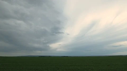 Time lapse of blowing summer blue gray clouds above gravel farm road Stock Footage 132837741