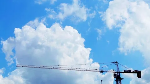 Time-lapse of blue cloudy sky with a construction crane Stock Footage 329836936