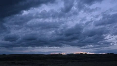 Time lapse of blue colored evening clouds moving from left to right  Stock Footage 242118938