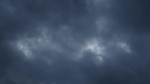 Time lapse of blue-gray storm clouds moving rapidly across the summer sky. The Stock Footage 335549998