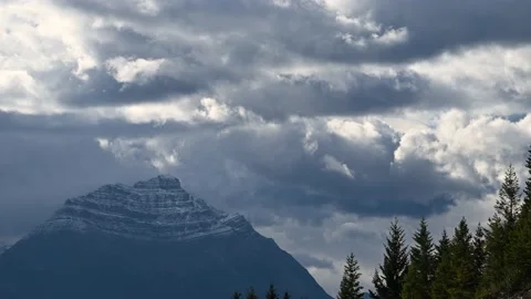 Time lapse blue grey clouds churning above a mountain.  Stock Footage 138911363