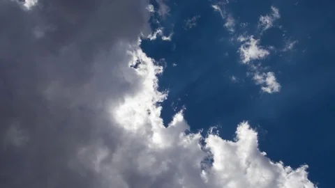 Time lapse of blue sky and sun rays coming through clouds isolated in the sky Stock Footage 75820332