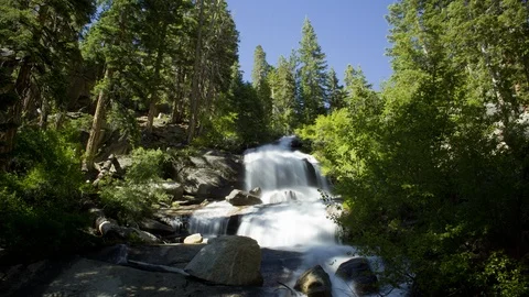 Time lapse of blue sky and a blurry waterfall at the Mount Whitney portal Stock Footage 91150778