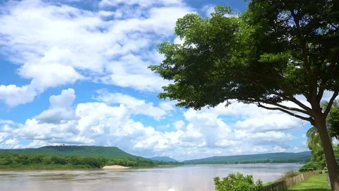 Time-lapse blue sky and clouds on river in sunshine day Stock Footage 155798701